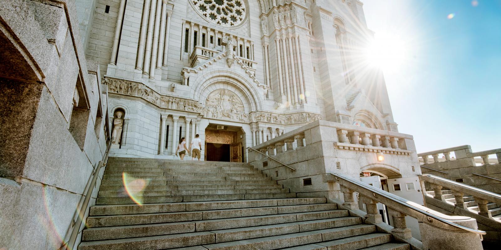 Front and exterior steps of the Sanctuary of Sainte-Anne-de-Beaupré on a sunny summer day.